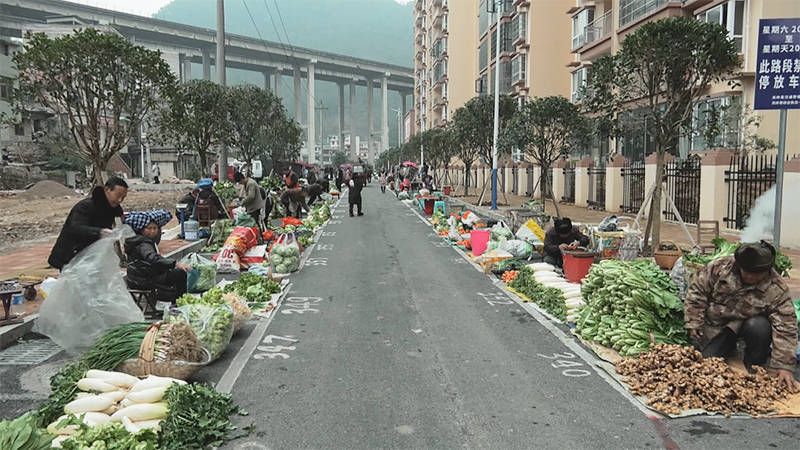 新建的水韵佳缘集贸市场，商贩在指定摊位摆摊营业.png